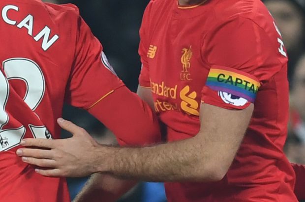 Liverpool's English midfielder Jordan Henderson wears a rainbow captain's armband in support of lesbian, gay, bisexual and transgender players and fans during the English Premier League football match between Liverpool and Sunderland at Anfield in Liverpool, north west England on November 26, 2016. / AFP / Paul ELLIS / RESTRICTED TO EDITORIAL USE. No use with unauthorized audio, video, data, fixture lists, club/league logos or 'live' services. Online in-match use limited to 75 images, no video emulation. No use in betting, games or single club/league/player publications. / (Photo credit should read PAUL ELLIS/AFP/Getty Images)